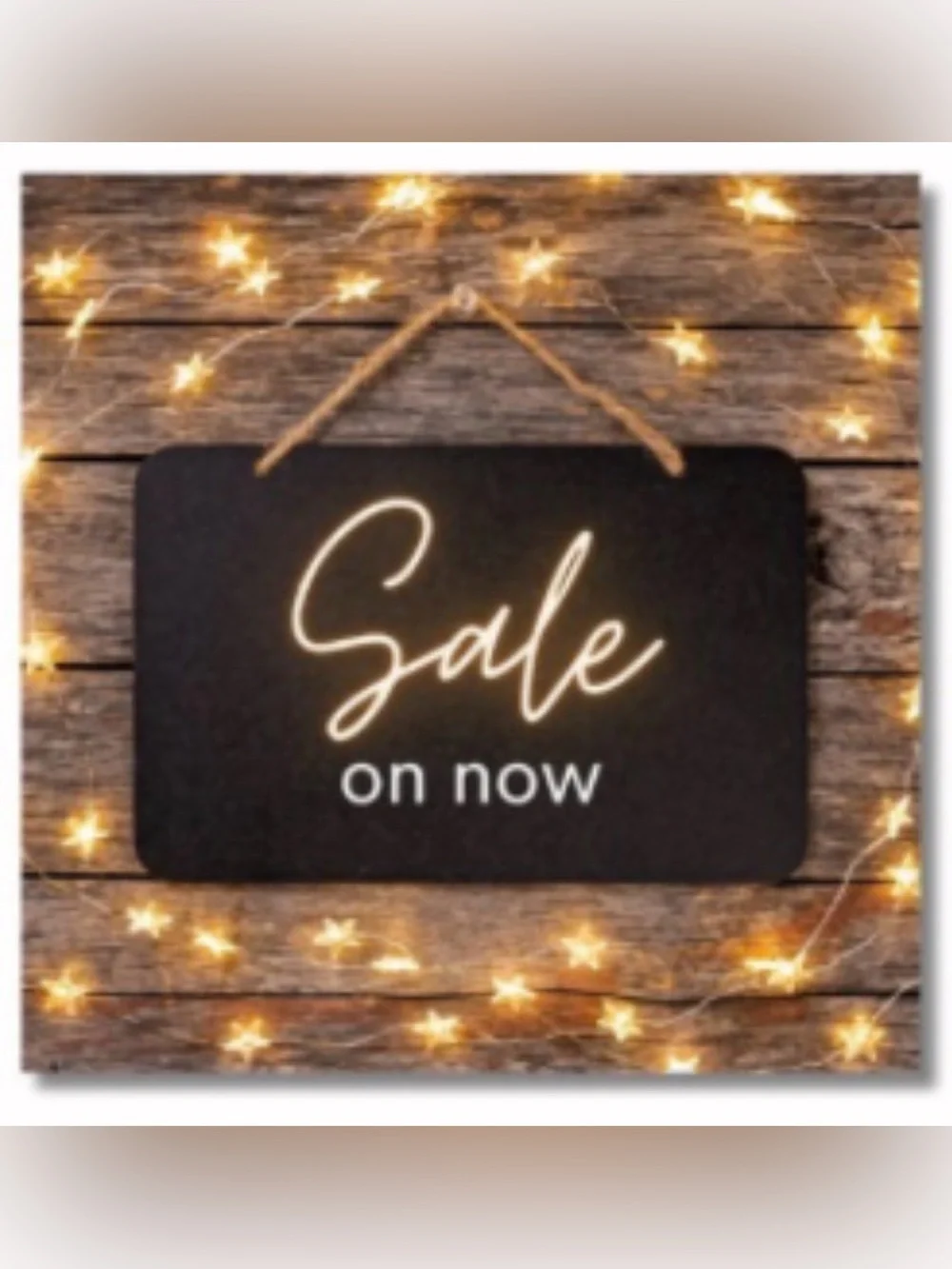 Black 'Sale on now' Hanging Sign with Warm String Lights